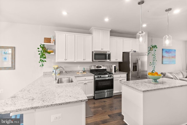22186 Mccormick Ter, Ashburn, VA 20148 - kitchen with stainless steel appliances, a sink, white cabinets, dark wood-type flooring, and a peninsula