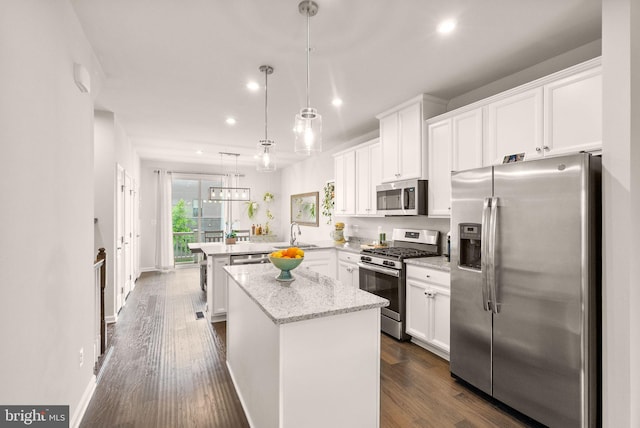22186 Mccormick Ter, Ashburn, VA 20148 - kitchen featuring appliances with stainless steel finishes, a peninsula, recessed lighting, a sink, and white cabinets
