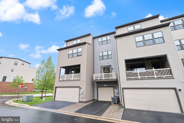 22186 Mccormick Ter, Ashburn, VA 20148 - townhome / multi-family property with a garage, driveway, and central AC unit