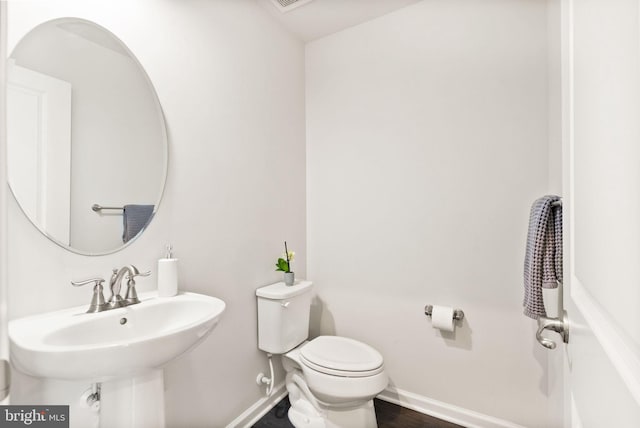 22186 Mccormick Ter, Ashburn, VA 20148 - bathroom with baseboards, toilet, and a sink