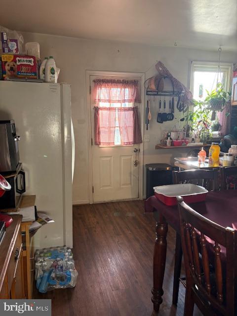 kitchen with freestanding refrigerator and wood finished floors