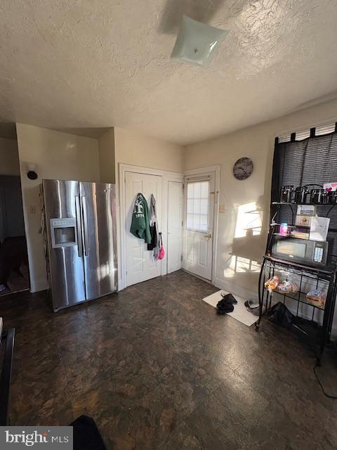 foyer featuring a textured ceiling