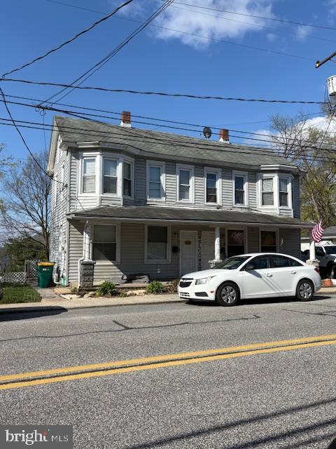 view of front of house featuring a chimney