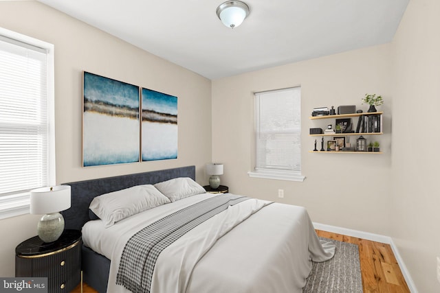 2512 N Marshall St, Philadelphia, PA 19133 - bedroom with baseboards, multiple windows, and wood finished floors