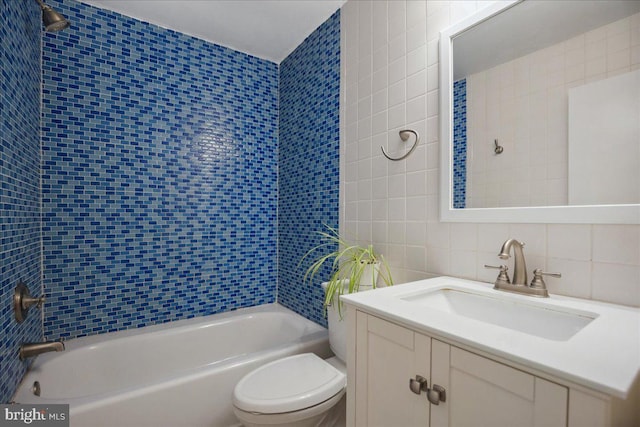 5650 Warren Dr, Huntingtown, MD 20639 - full bathroom featuring vanity, tub / shower combination, toilet, tile walls, and tasteful backsplash