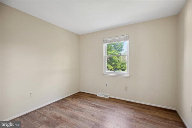 5650 Warren Dr, Huntingtown, MD 20639 - spare room with baseboards, wood finished floors, and visible vents