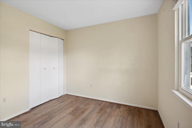 5650 Warren Dr, Huntingtown, MD 20639 - unfurnished bedroom with baseboards, wood finished floors, and a closet