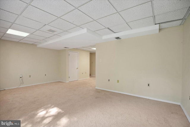 5650 Warren Dr, Huntingtown, MD 20639 - finished below grade area featuring baseboards, visible vents, light carpet, and a paneled ceiling