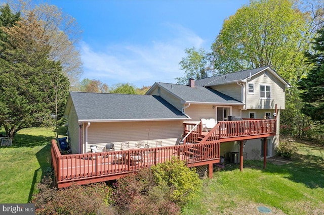 5650 Warren Dr, Huntingtown, MD 20639 - rear view of house featuring a chimney, a wooden deck, central air condition unit, a yard, and a shingled roof