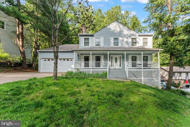 2320 Harpoon Dr, Stafford, VA 22554 - view of front of home featuring covered porch, an attached garage, driveway, a chimney, and a front yard