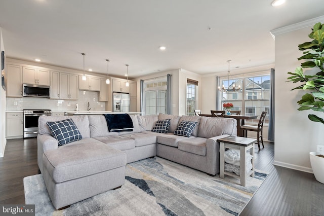 living area featuring an inviting chandelier, baseboards, dark wood-style floors, and recessed lighting