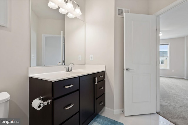 bathroom with vanity, baseboards, tile patterned flooring, and visible vents