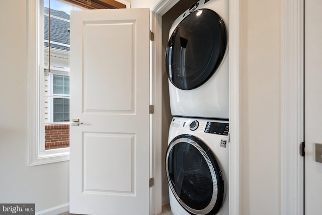 laundry area featuring stacked washer / dryer and laundry area