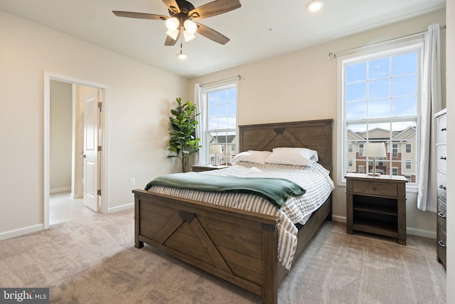 carpeted bedroom with baseboards and a ceiling fan