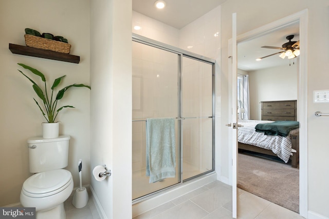 ensuite bathroom with a shower stall, tile patterned floors, toilet, and connected bathroom