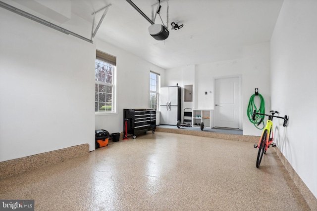 garage featuring a garage door opener and electric panel