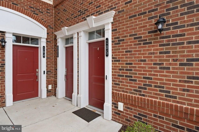 view of exterior entry with brick siding