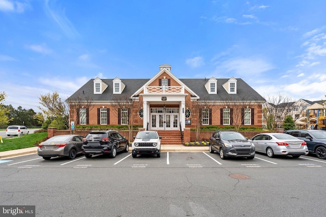 view of building exterior with uncovered parking