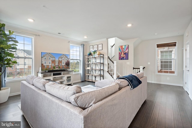 living room featuring baseboards, dark wood finished floors, and a wealth of natural light