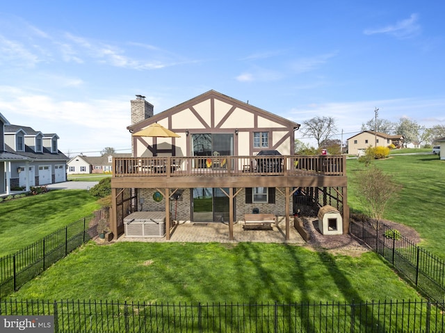 back of house with a patio area, a wooden deck, a lawn, and a chimney