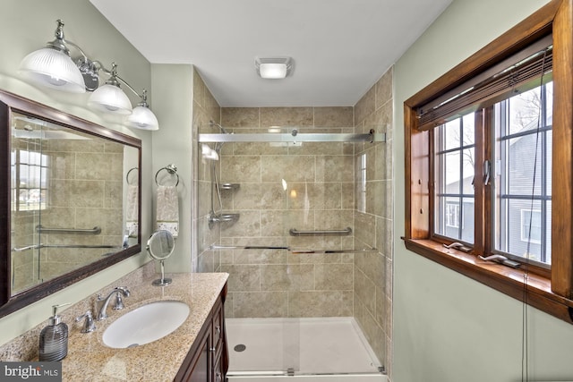 full bath featuring a stall shower and vanity