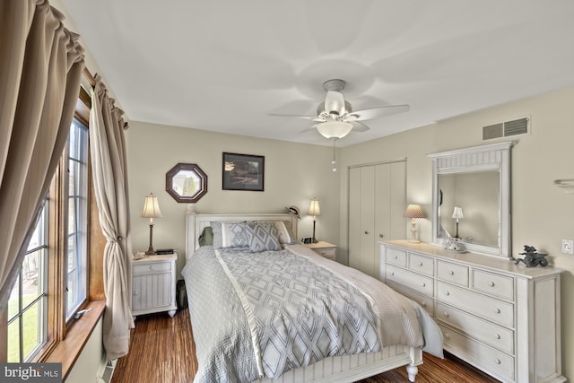 bedroom with visible vents, a ceiling fan, and wood finished floors