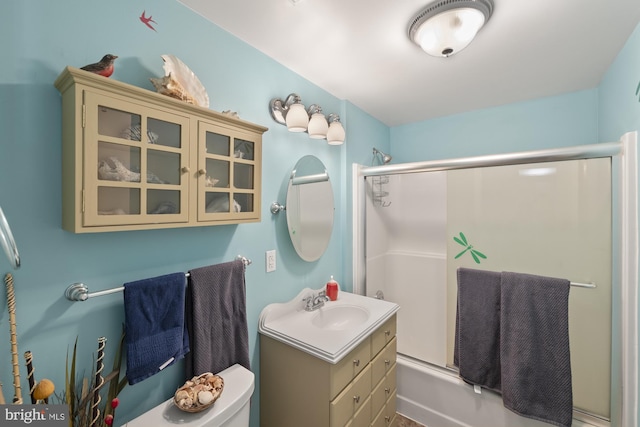 bathroom with toilet, vanity, and shower / bath combination with glass door