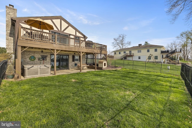 back of property with a yard, a fenced backyard, a patio, a chimney, and a deck