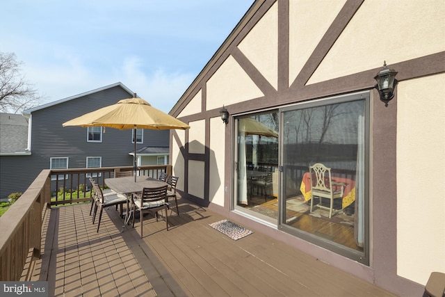 wooden terrace with outdoor dining area