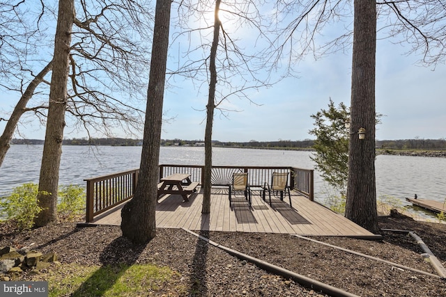 view of dock featuring a deck with water view