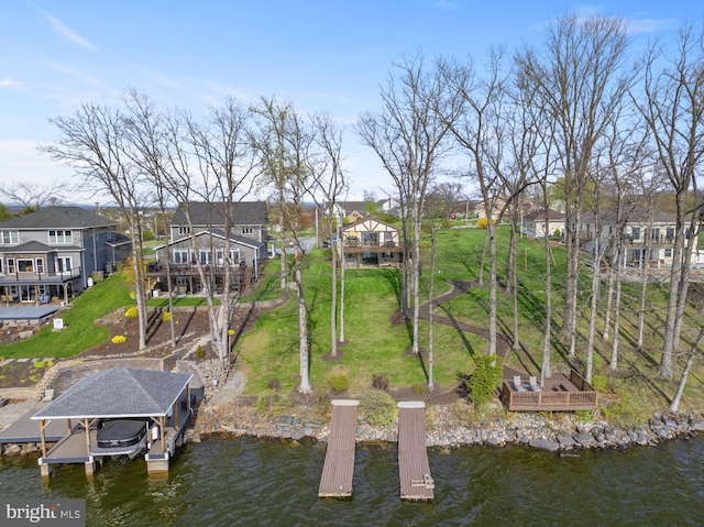 dock area with a yard, a deck with water view, and a residential view