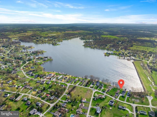 drone / aerial view featuring a view of trees and a water view