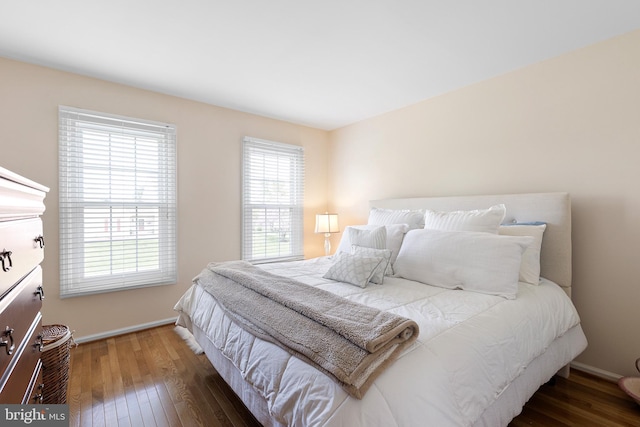 bedroom featuring hardwood / wood-style floors and baseboards