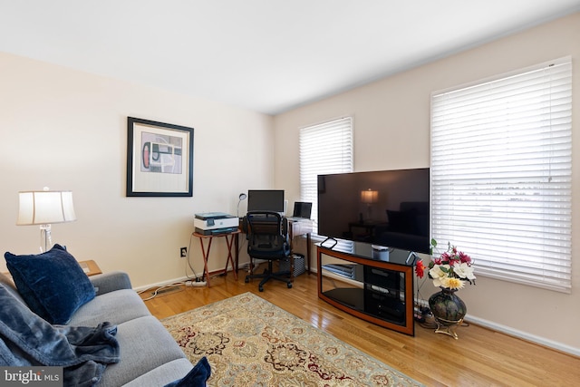 office space with wood finished floors and baseboards