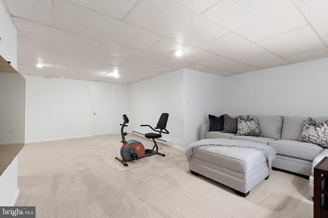workout room featuring a paneled ceiling and carpet