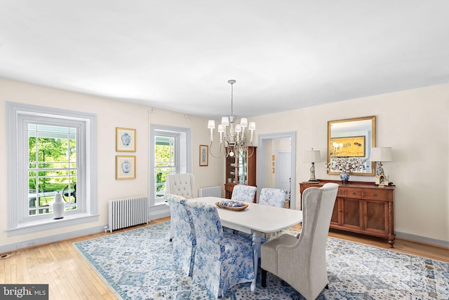 36437 Whispering Springs Ct, Purcellville, VA 20132 - dining space featuring radiator, a chandelier, light wood-style floors, and baseboards