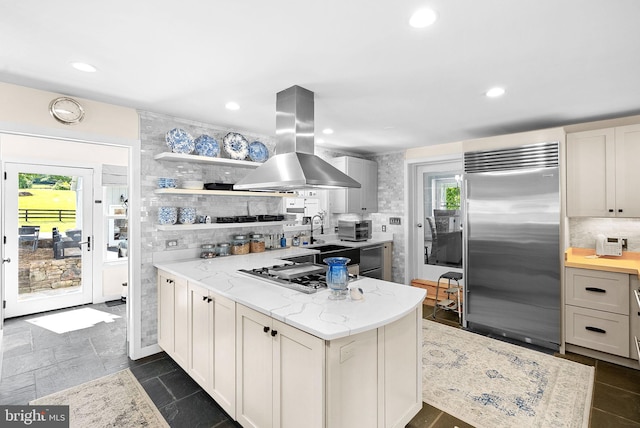 36437 Whispering Springs Ct, Purcellville, VA 20132 - kitchen with stainless steel appliances, island range hood, open shelves, decorative backsplash, and light stone counters