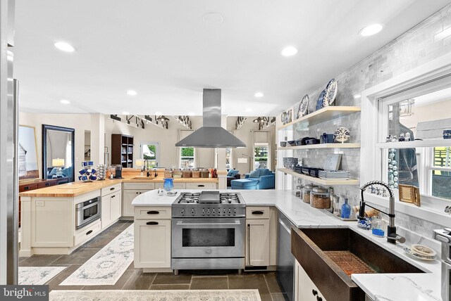 36437 Whispering Springs Ct, Purcellville, VA 20132 - kitchen with stainless steel appliances, island exhaust hood, a sink, butcher block countertops, and recessed lighting