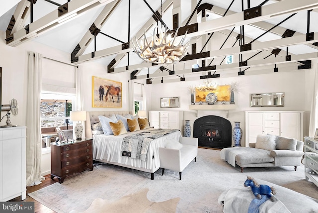 36437 Whispering Springs Ct, Purcellville, VA 20132 - bedroom with high vaulted ceiling, a warm lit fireplace, a chandelier, wood finished floors, and beamed ceiling