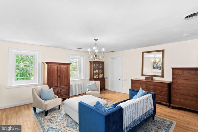 36437 Whispering Springs Ct, Purcellville, VA 20132 - living area with radiator heating unit, a chandelier, light wood-type flooring, and baseboards