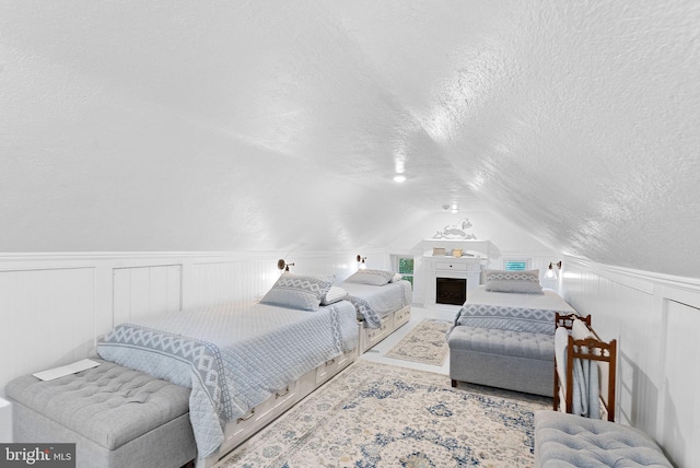 36437 Whispering Springs Ct, Purcellville, VA 20132 - bedroom with a textured ceiling, lofted ceiling, a decorative wall, and wainscoting