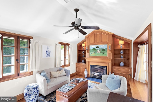 36437 Whispering Springs Ct, Purcellville, VA 20132 - living area featuring lofted ceiling, light wood-style floors, baseboards, and a fireplace with flush hearth