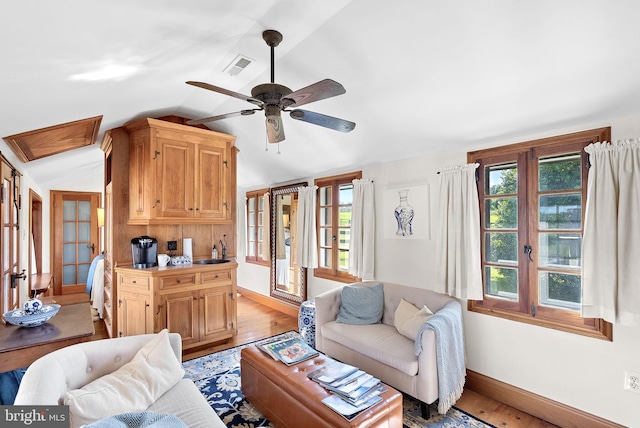 36437 Whispering Springs Ct, Purcellville, VA 20132 - living room featuring light wood finished floors, vaulted ceiling, healthy amount of natural light, baseboards, and a ceiling fan
