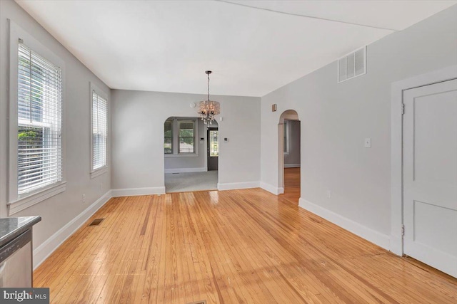 3404 Chesley Ave, Baltimore, MD 21234 - unfurnished dining area with arched walkways, a chandelier, light wood-style floors, and baseboards