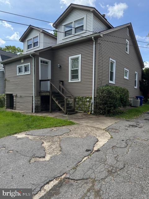 back of property with central AC