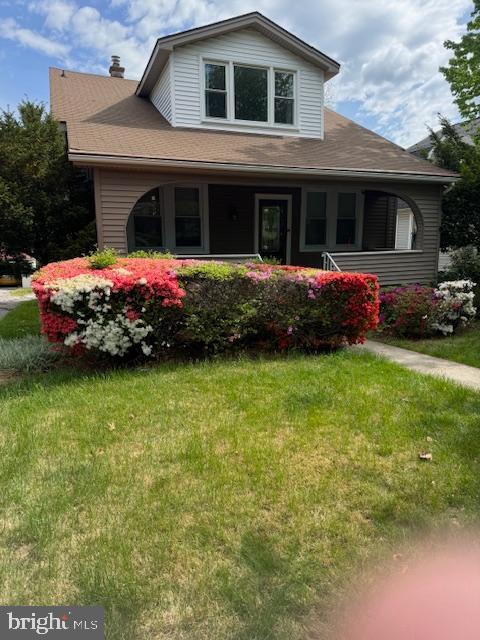 3404 Chesley Ave, Baltimore, MD 21234 - view of front of home featuring covered porch, a front lawn, and a chimney