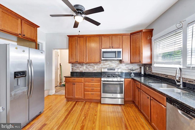 3404 Chesley Ave, Baltimore, MD 21234 - kitchen featuring stainless steel appliances, a sink, brown cabinetry, and light wood-type flooring