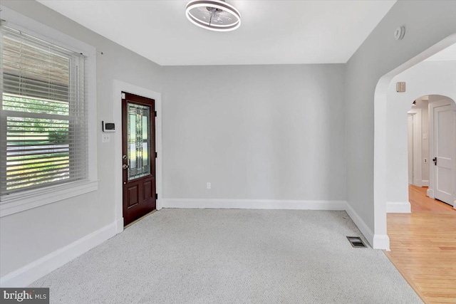 3404 Chesley Ave, Baltimore, MD 21234 - spare room with arched walkways, baseboards, and light carpet