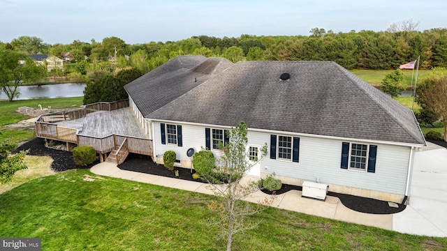 1081 Caldwell Corner Rd, Townsend, DE 19734 - rear view of house with a lawn, a patio, a shingled roof, and a deck with water view
