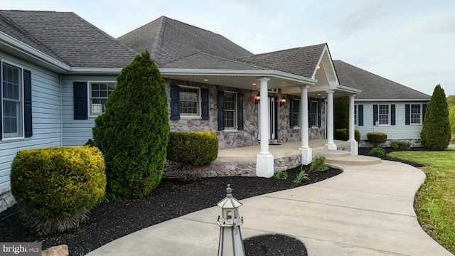 1081 Caldwell Corner Rd, Townsend, DE 19734 - view of front of house with roof with shingles, covered porch, and stone siding